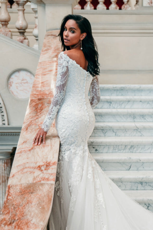 Model wearing a gowns with sleeves collection dress