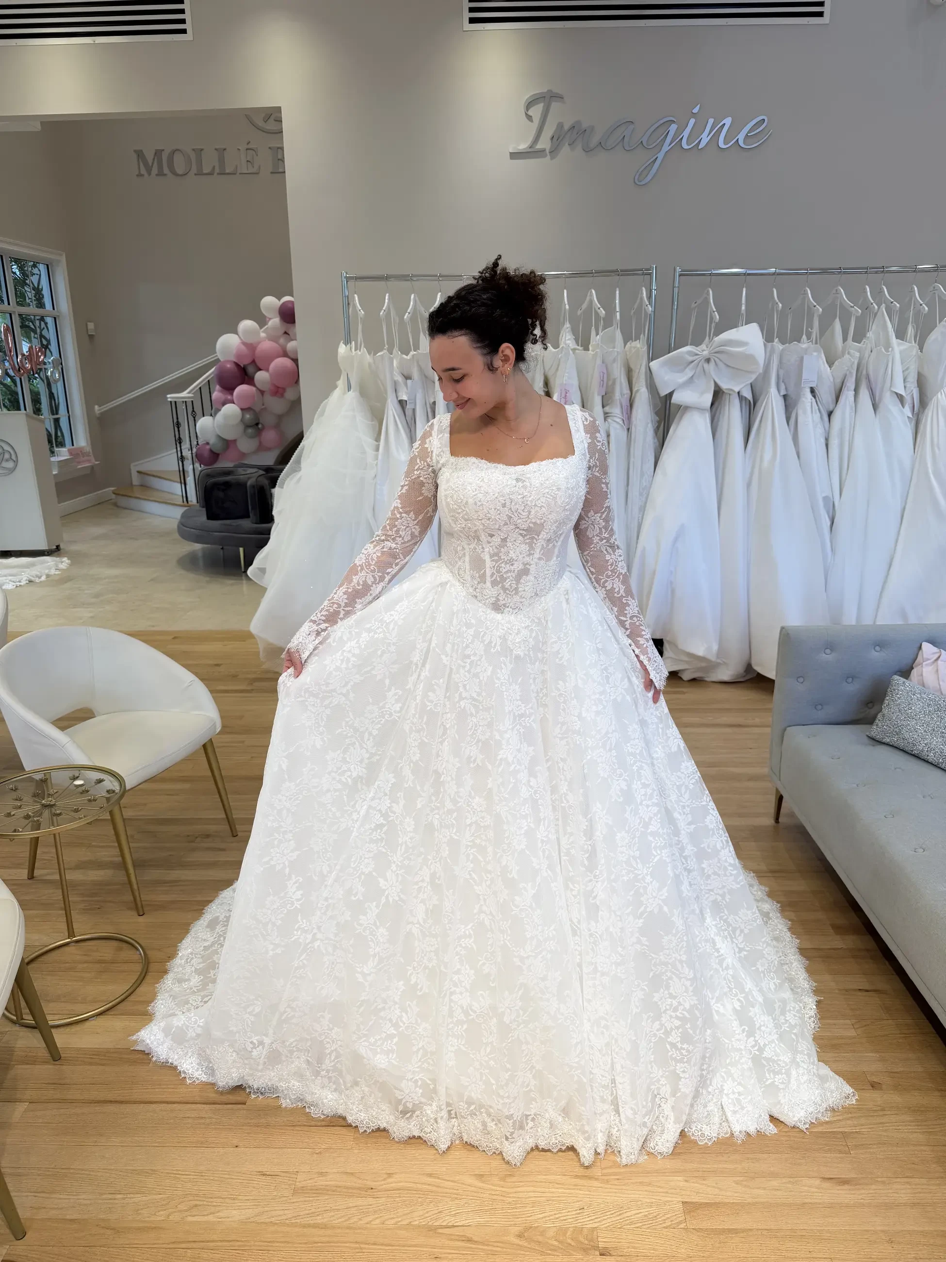 model is wearing a long sleeve square neckline wedding dress