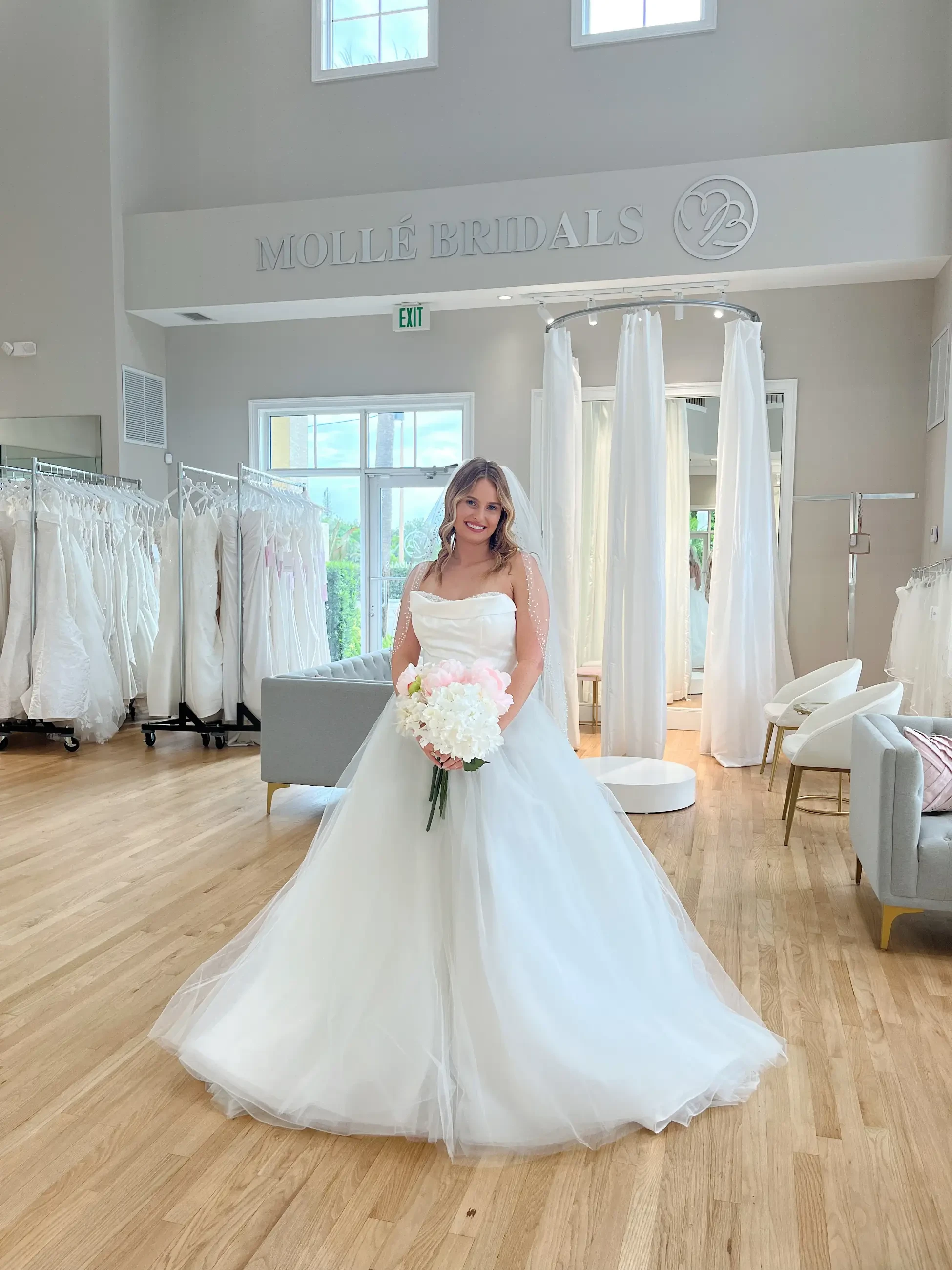 model is wearing a strapless ball gown wedding dress