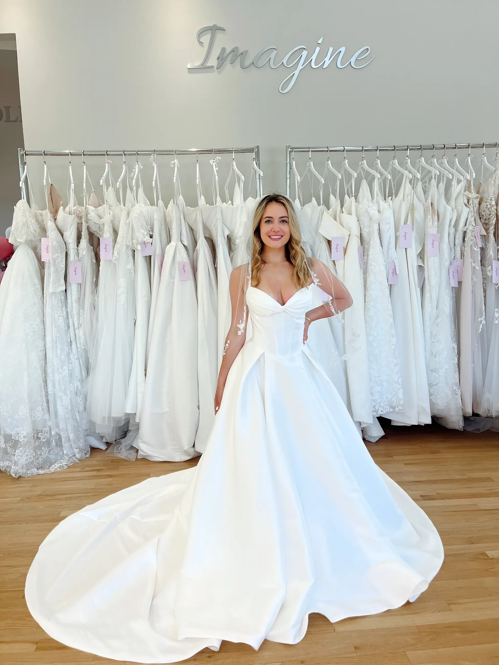 model is wearing a sleeveless basque waist wedding dress