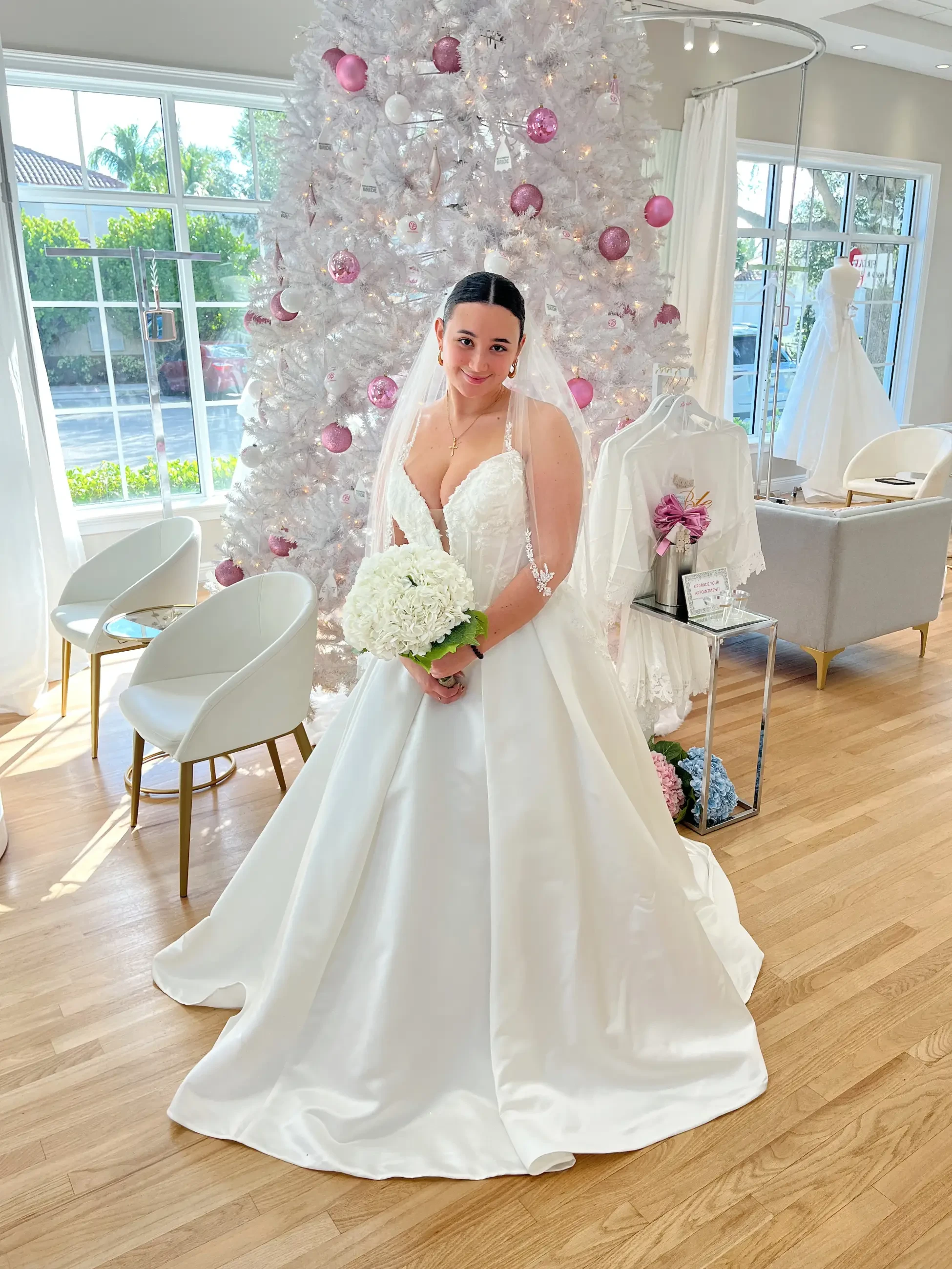 model is wearing a sleeveless ball gown wedding dress