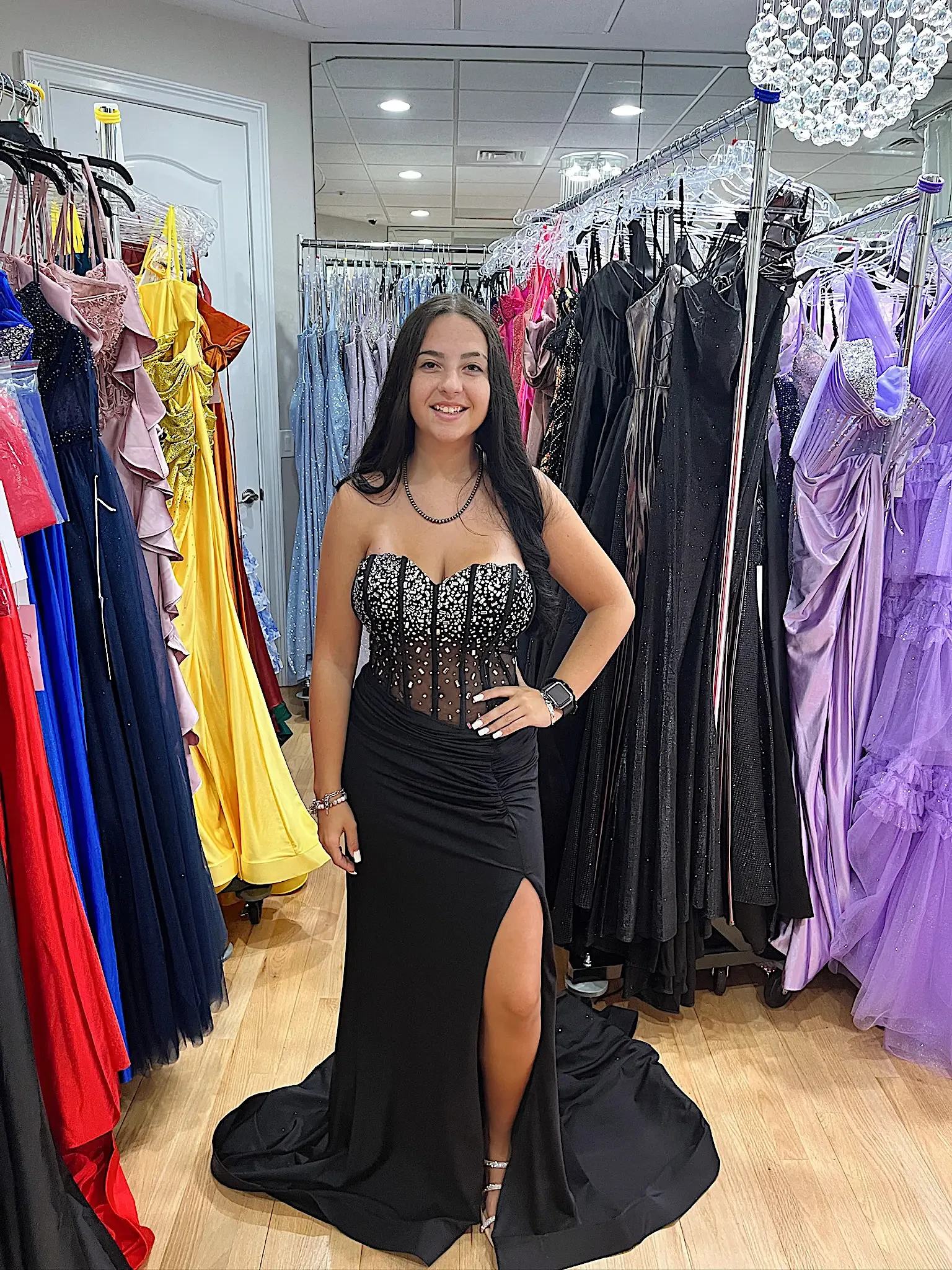 model is wearing a black sparkly prom dress