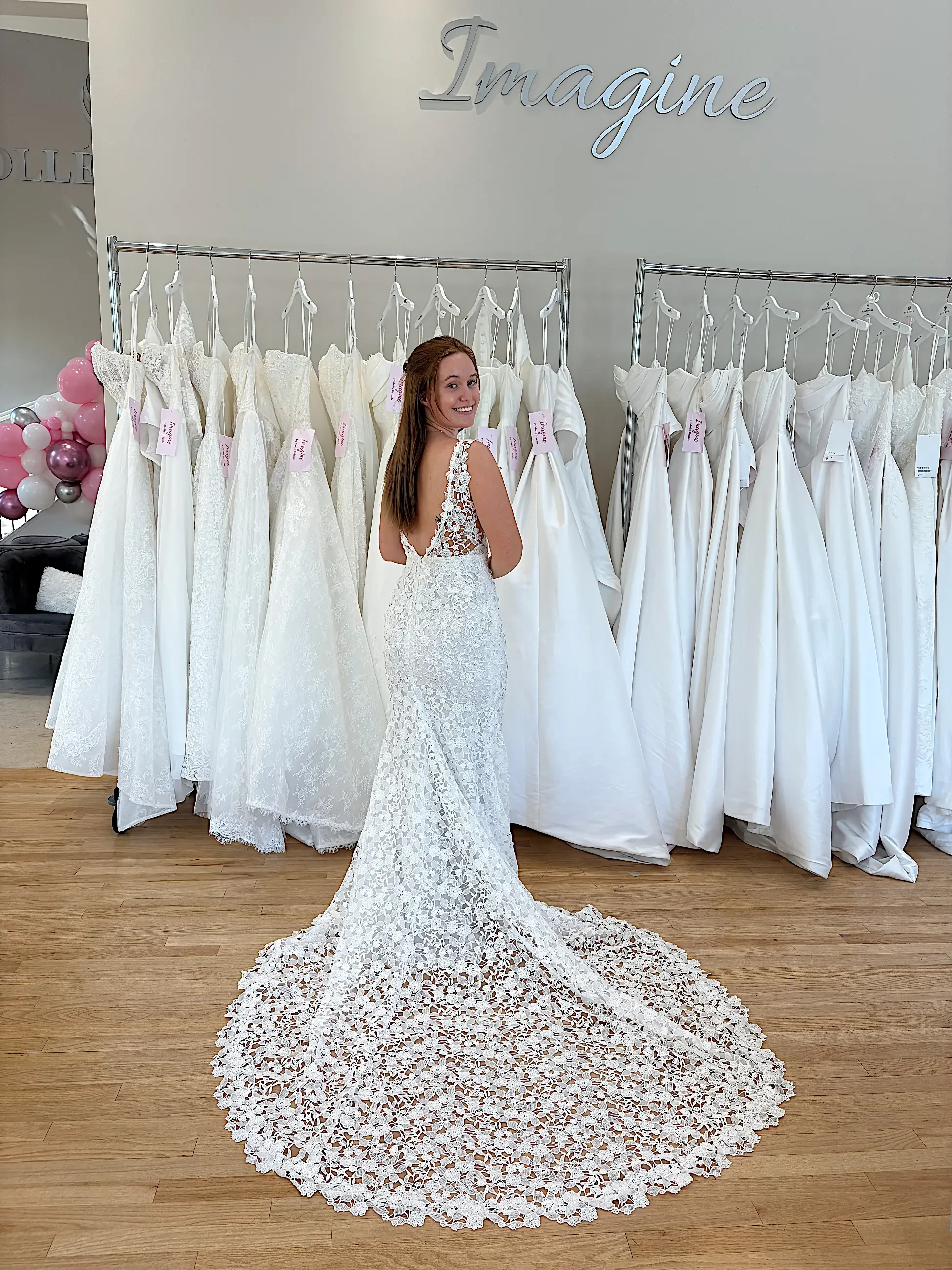 image shows a model wearing an open back wedding gown