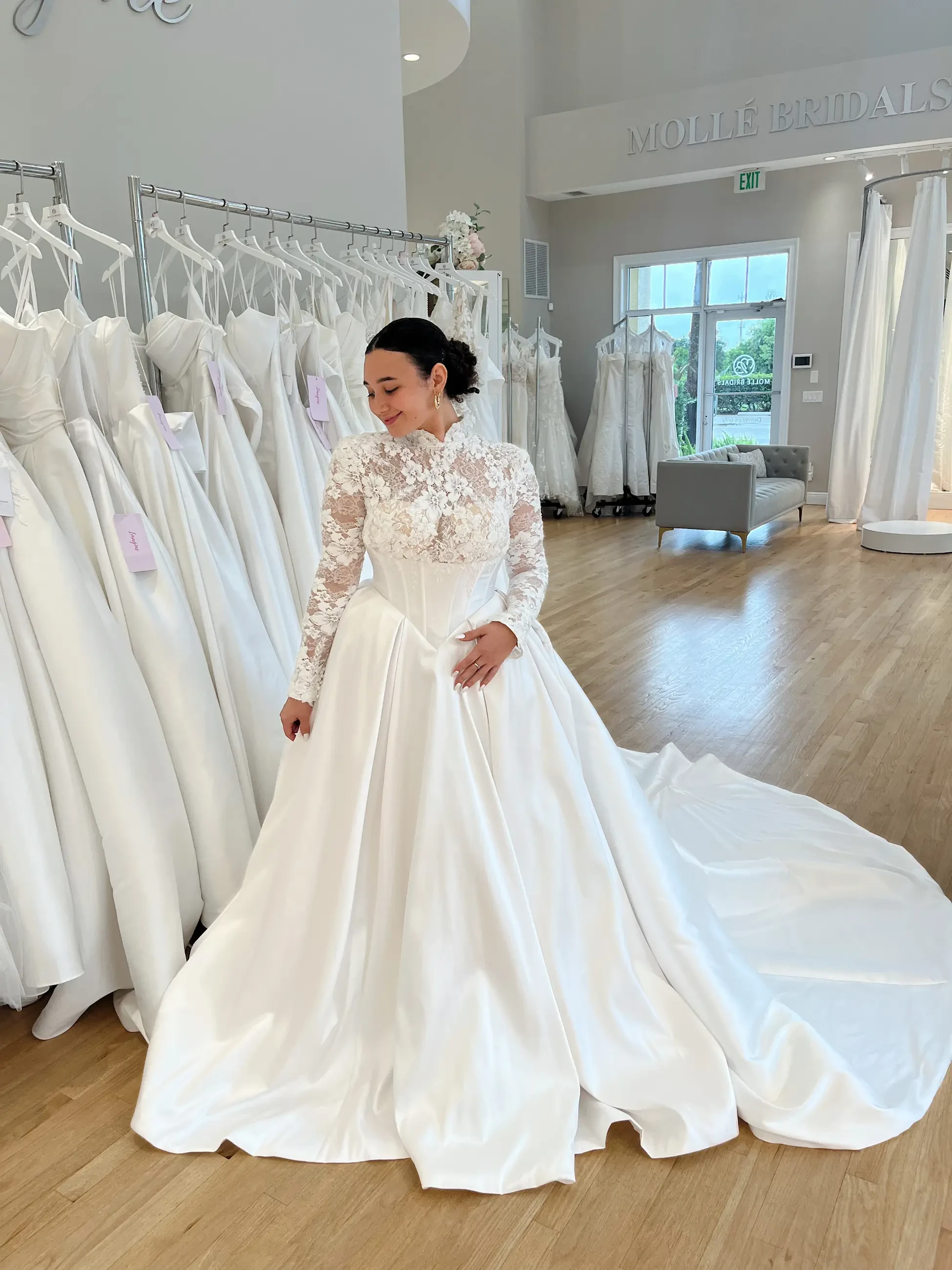 model is wearing an a-line basque waist long sleeve wedding dress