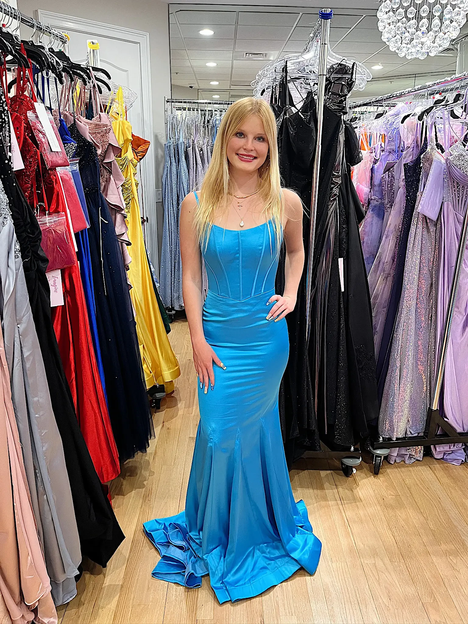 model is wearing a vibrant blue prom dress