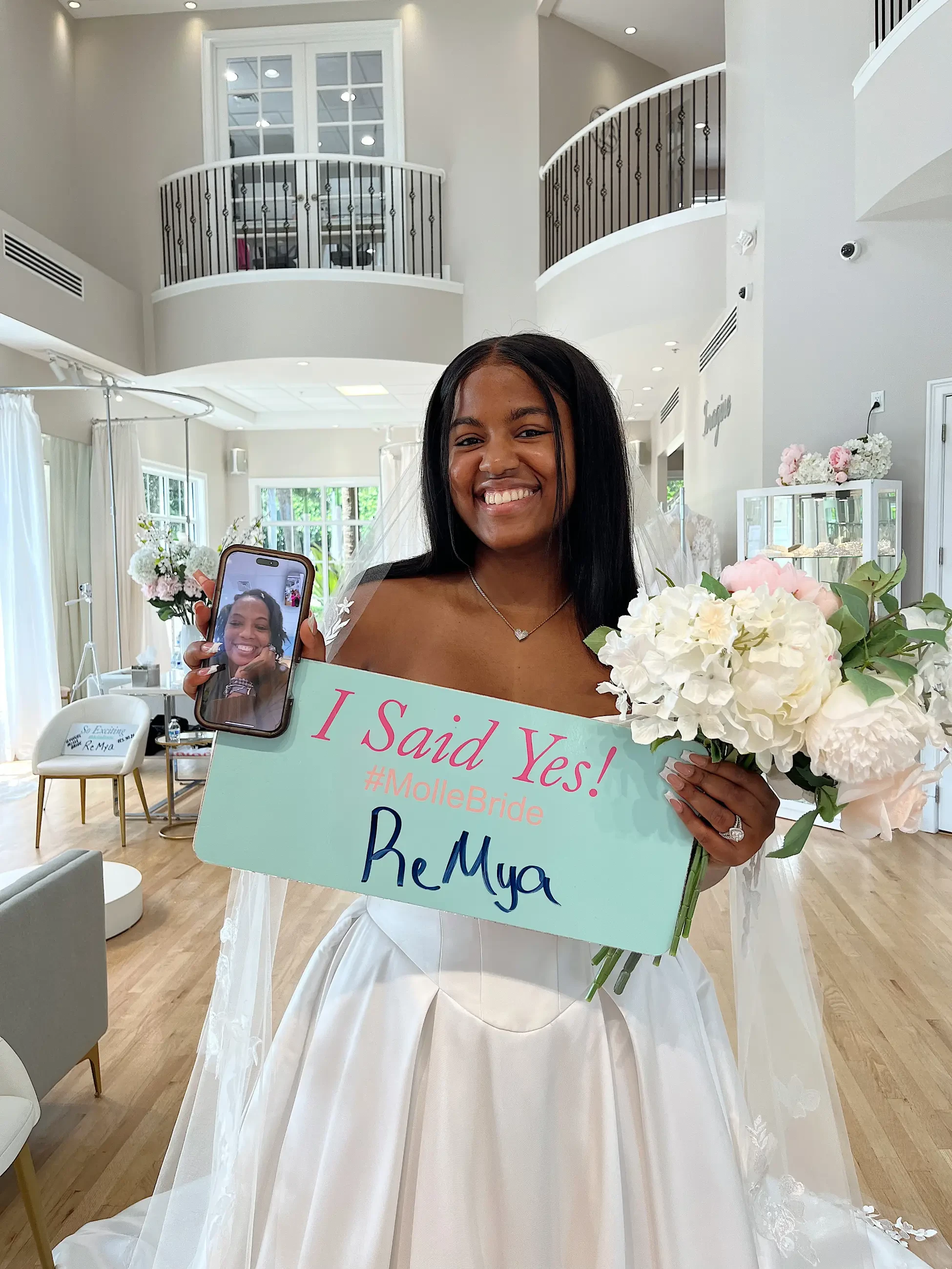 image shows a bride holding a sign that says she said yes to the dress