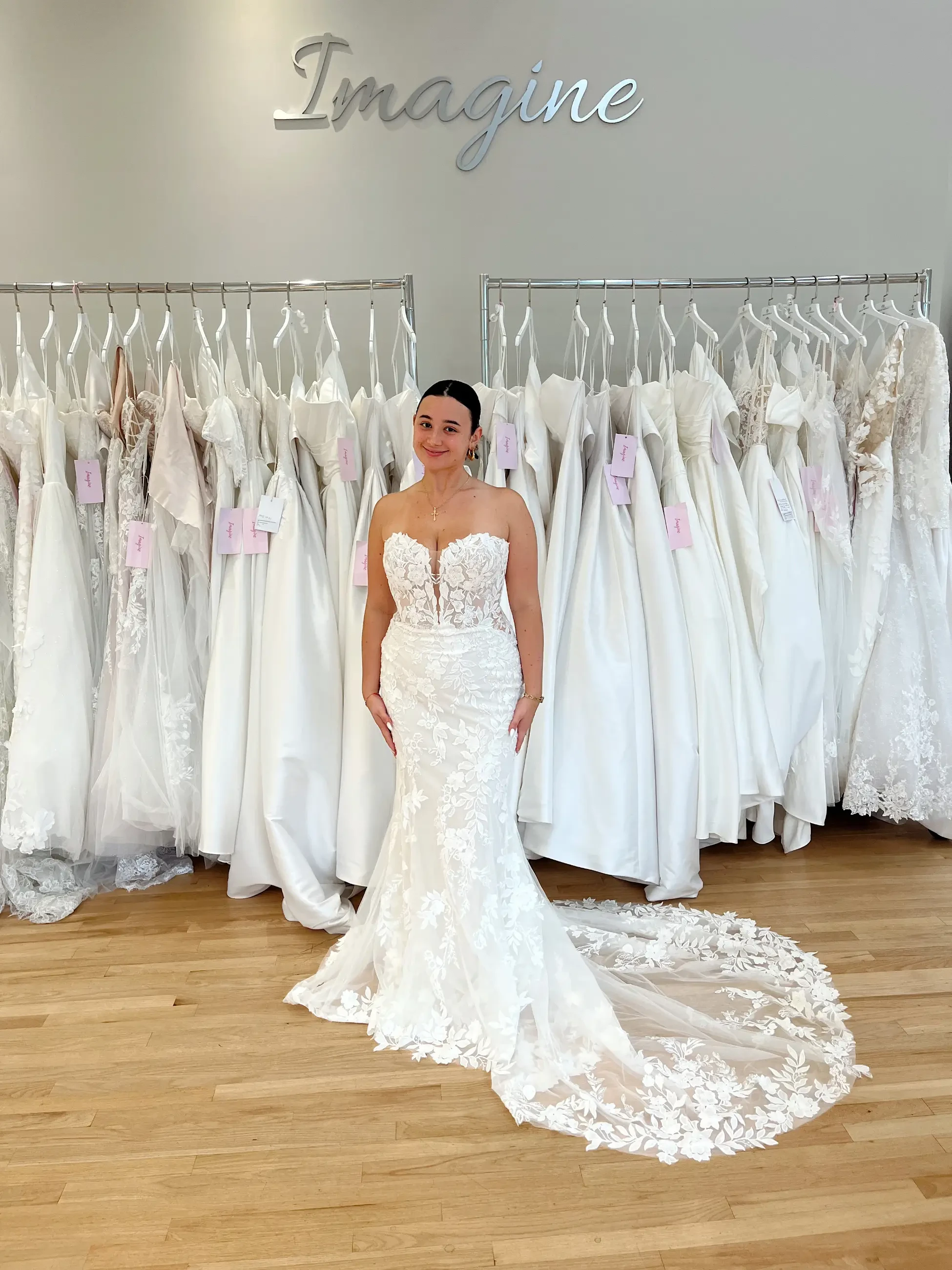model is wearing a strapless lace fit and flare wedding dress