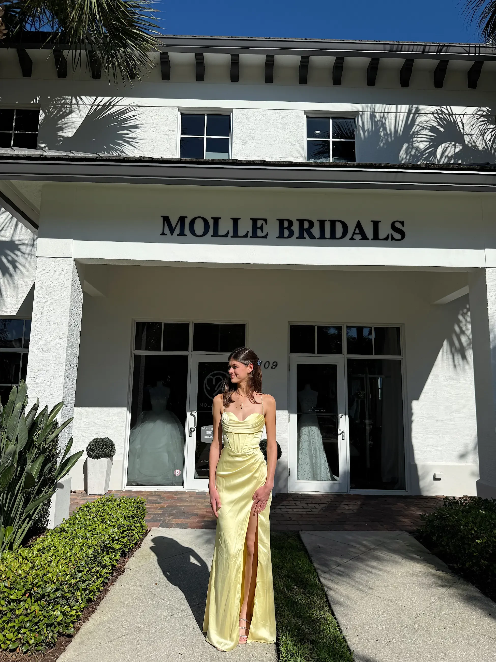 model is wearing a yellow prom dress