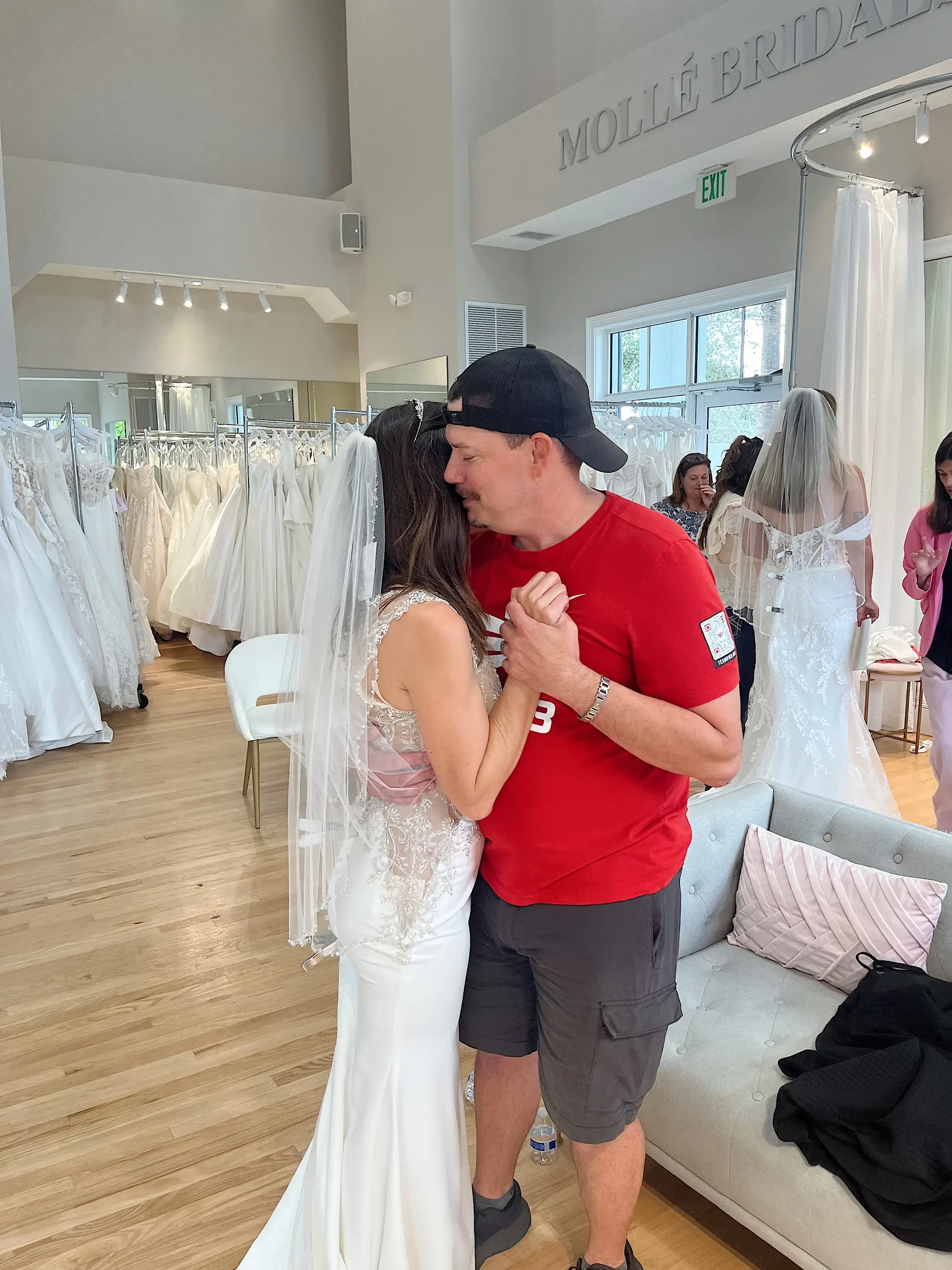 image shows a bride and a loved one hugging