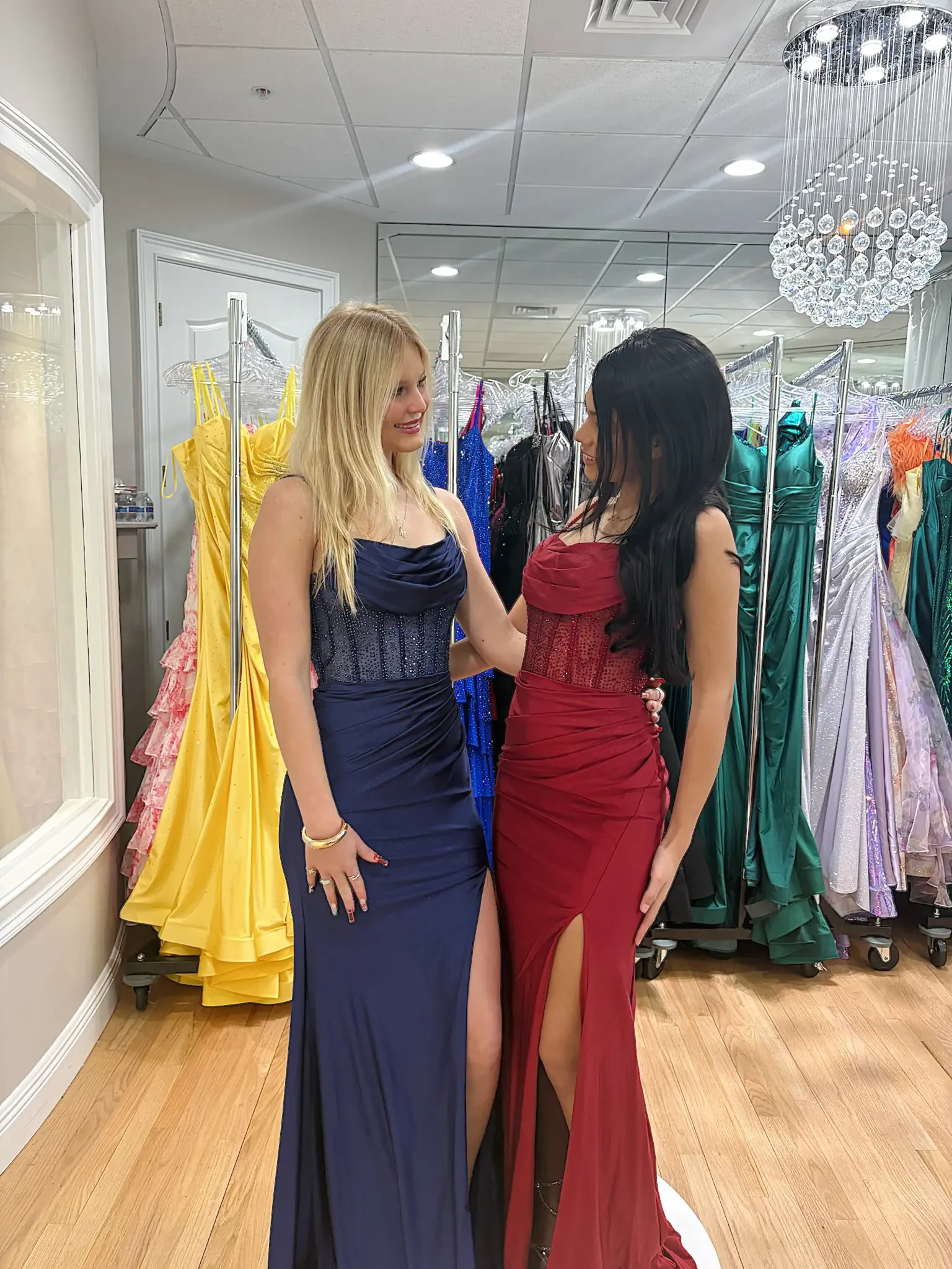 image shows a model wearing four prom dresses
