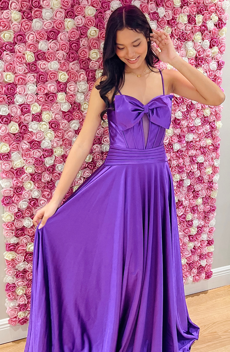 model wearing a purple prom dress ball gown