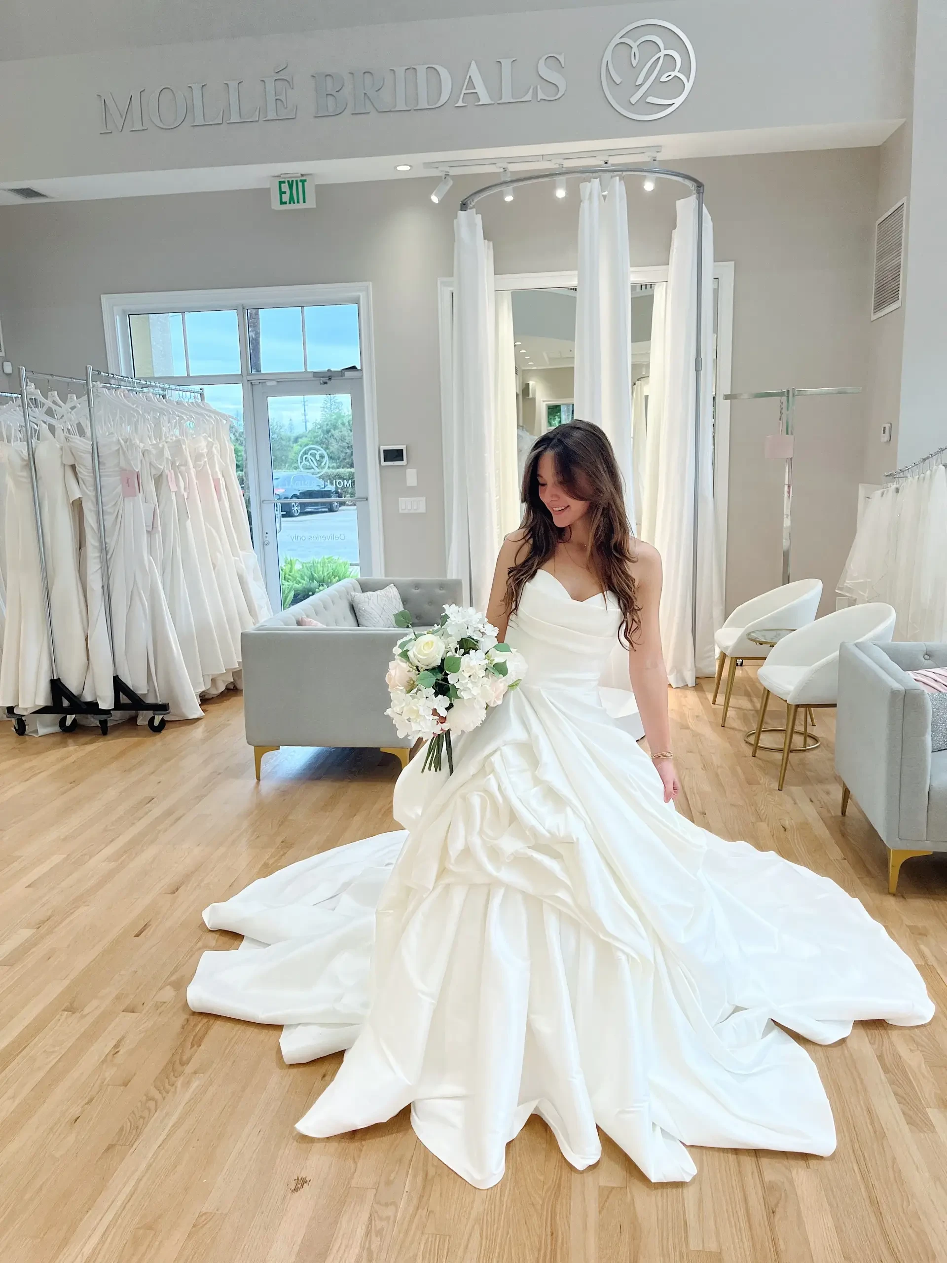 model is wearing a bold strapless ball gown wedding dress