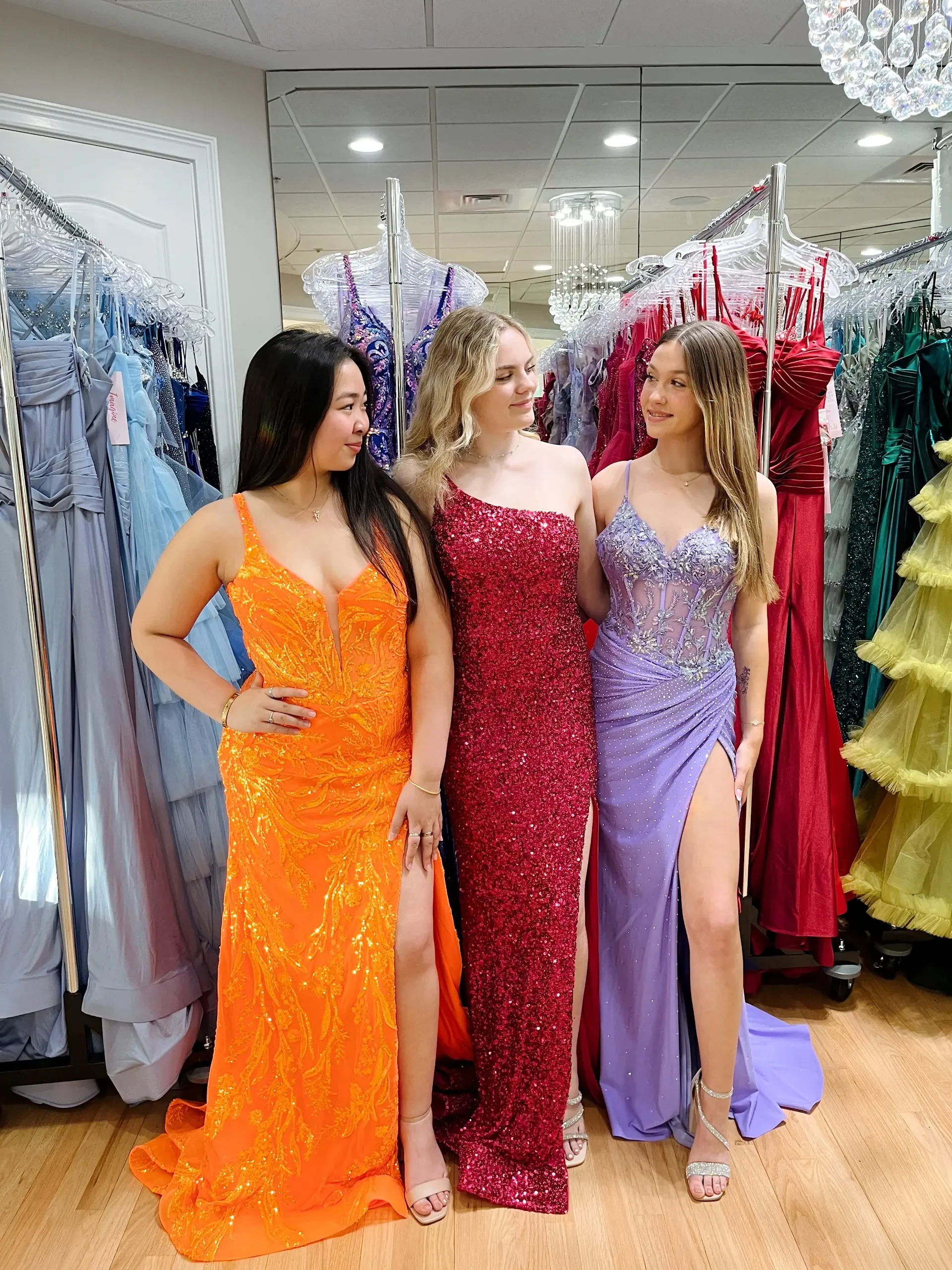 image shows three models wearing floor length evening gowns from molle bridals