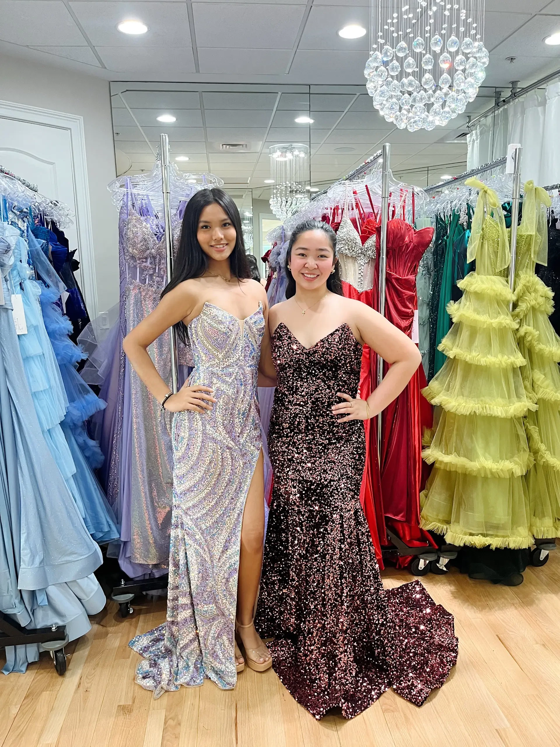 image shows two models wearing beaded evening gowns 