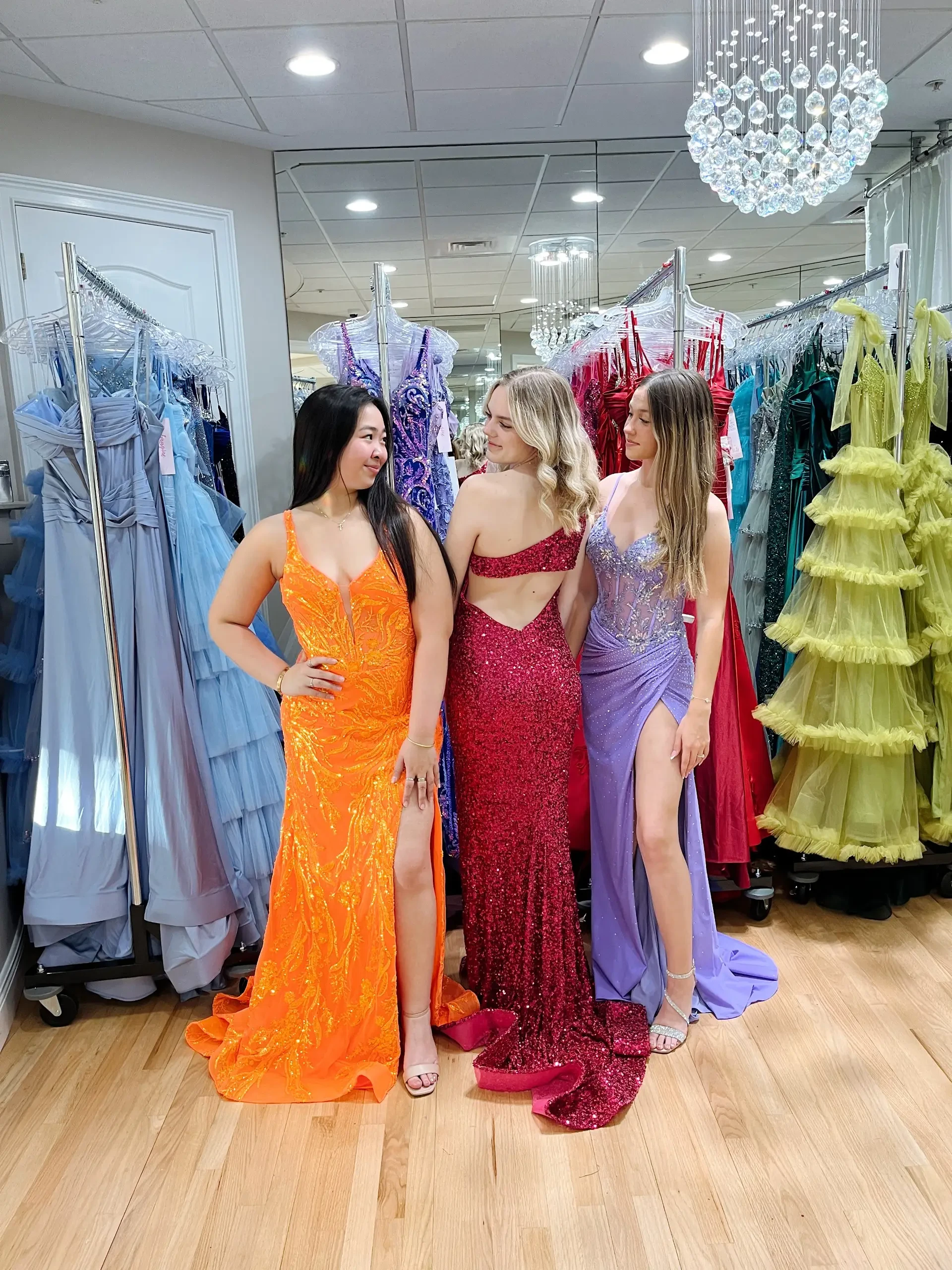 image shows three models wearing evening gowns from molle bridals