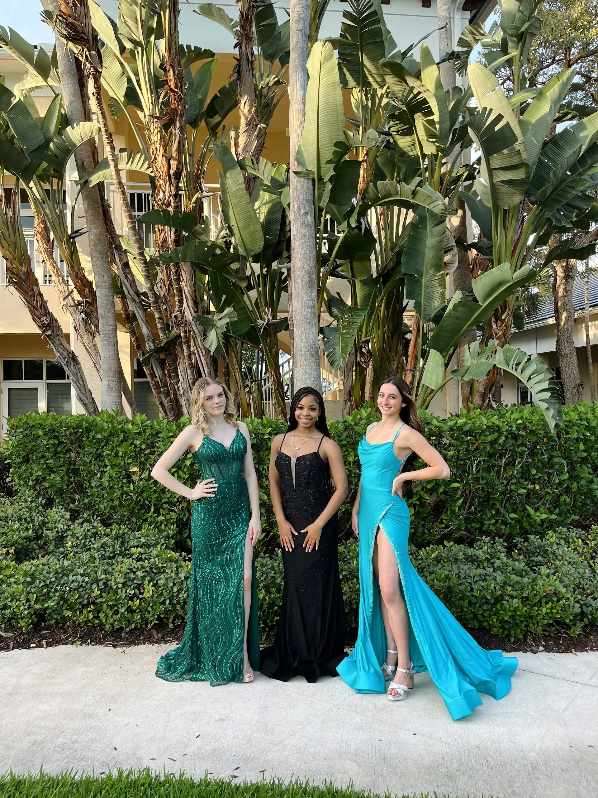 image shows three models wearing evening gowns from molle bridals