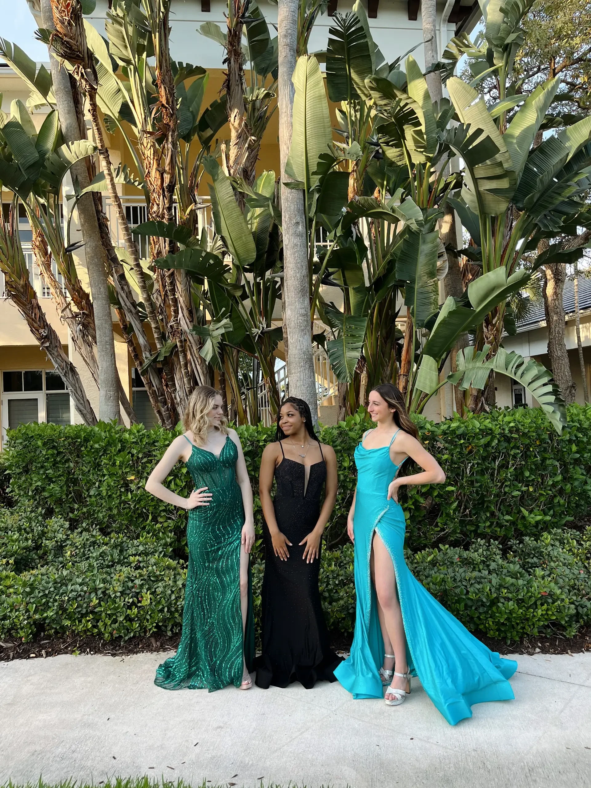 image shows three models wearing floor length evening gowns from molle bridals